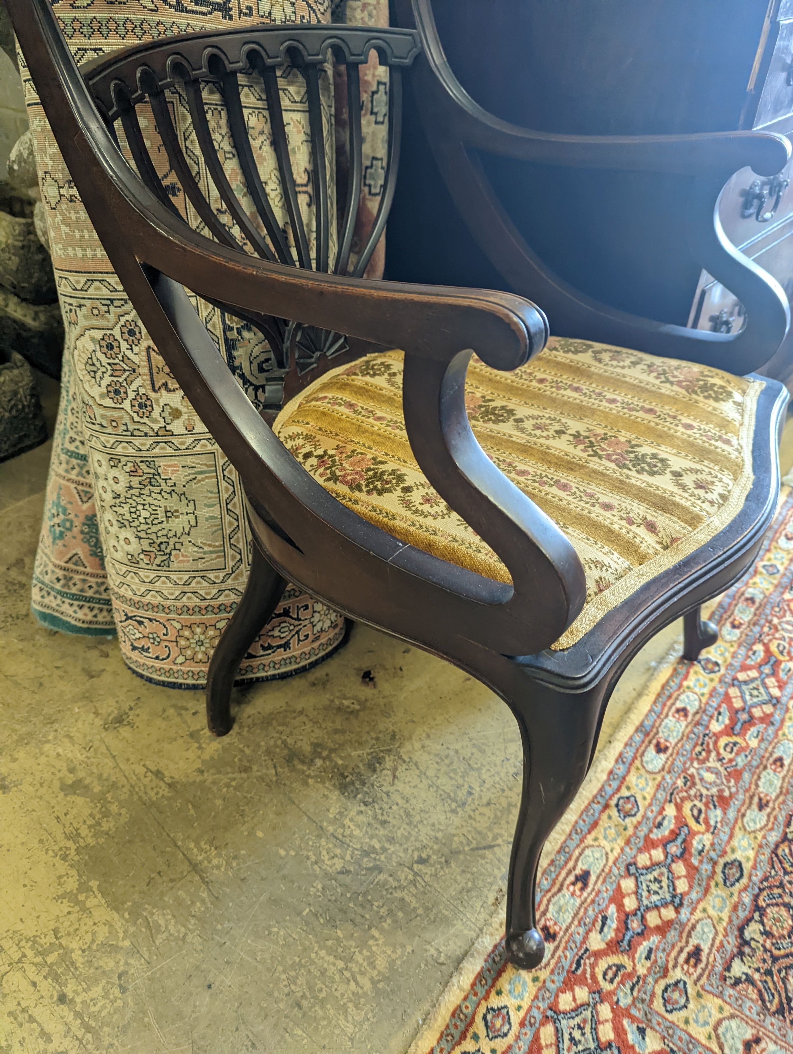 A late Victorian carved mahogany elbow chair